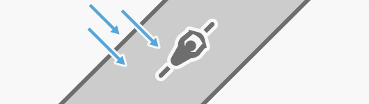 A bicyclist pedaling at an angle from the wind A bicyclist pedaling at an angle from the wind